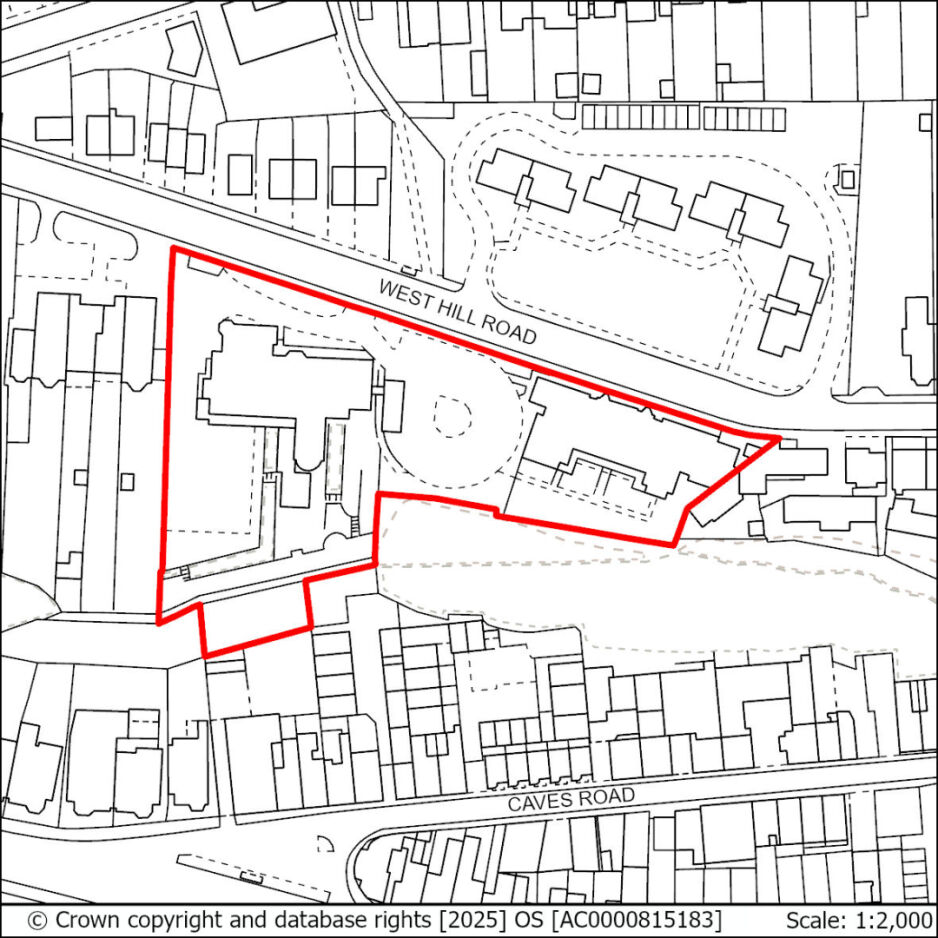 A map showing a property boundary outlined in red, located between West Hill Road and Caves Road, with surrounding buildings and streets, including a circular area in the centre of the property.