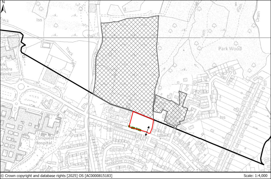 Detailed map showing a residential area with planned development boundaries marked in red and black, featuring surrounding wooded areas, roads, and specific land plots.